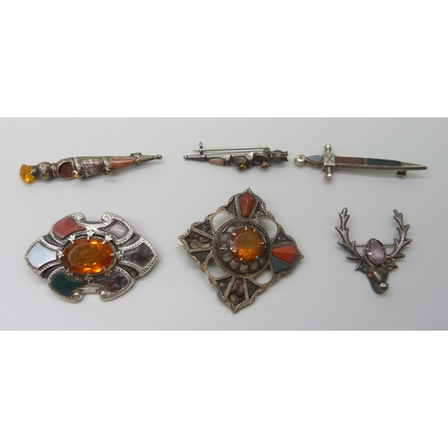 7105 - Scottish hardstone set jewellery including four silver brooches and a large white metal brooch, silv... 