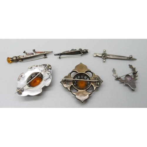 7105 - Scottish hardstone set jewellery including four silver brooches and a large white metal brooch, silv... 