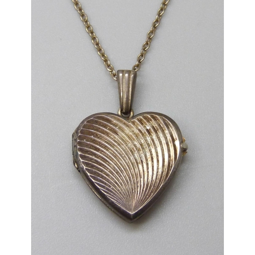 7113 - A Georg Jensen silver heart locket on a chain, 4.5g, 2.5cm including bale