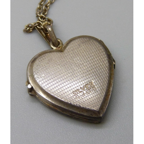 7113 - A Georg Jensen silver heart locket on a chain, 4.5g, 2.5cm including bale