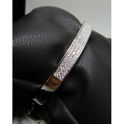 7132 - A silver bangle set with three rows of cubic Zirconia, 16.6g, band 0.6cm wide