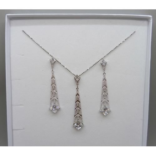 7142 - A pair of silver Art Deco style Swarovski cubic zirconia drop earrings and matching pendant by Cavan... 