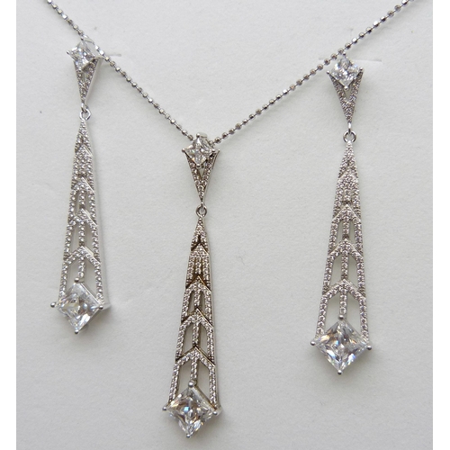 7142 - A pair of silver Art Deco style Swarovski cubic zirconia drop earrings and matching pendant by Cavan... 