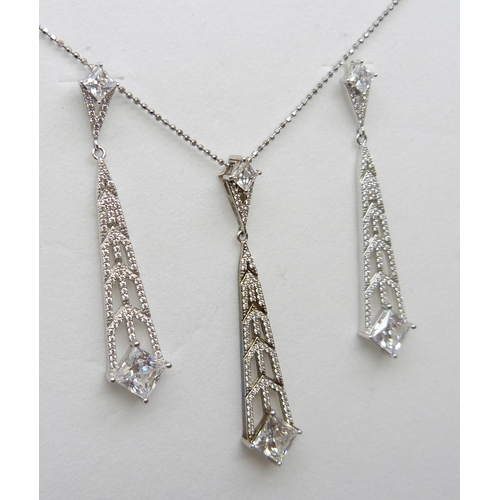 7142 - A pair of silver Art Deco style Swarovski cubic zirconia drop earrings and matching pendant by Cavan... 