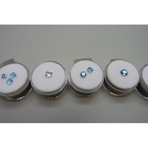 7145 - A selection of oval, cushion, square and round cut blue topaz stones