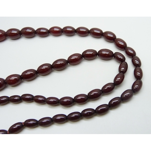 7148 - A sherry amber necklace, 51g, largest bead 2.4 x 1.7cm