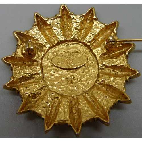 7150 - A Chanel gold tone CC logo sun shield brooch marked Chanel, made in France, 4.3cm