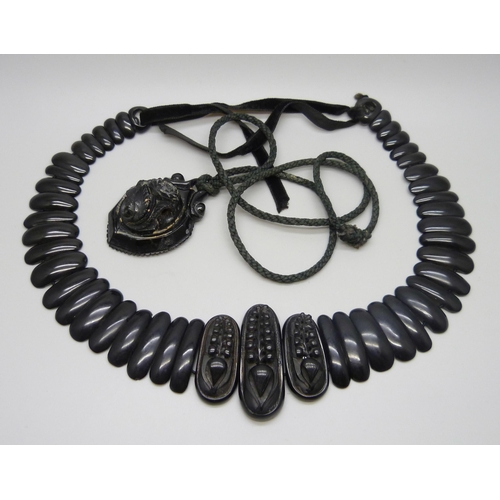 7157 - A circa 1900 Art Nouveau carved Whitby jet collar panel necklace, 56g, together with a pendant, 20g