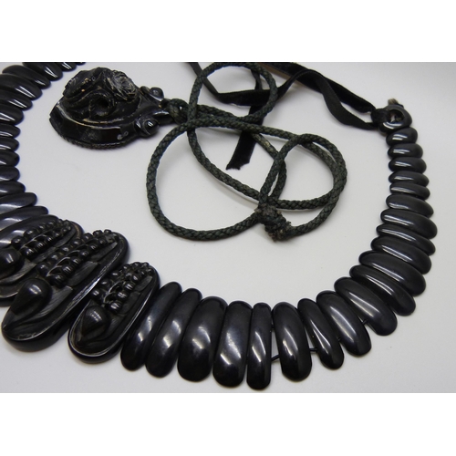 7157 - A circa 1900 Art Nouveau carved Whitby jet collar panel necklace, 56g, together with a pendant, 20g