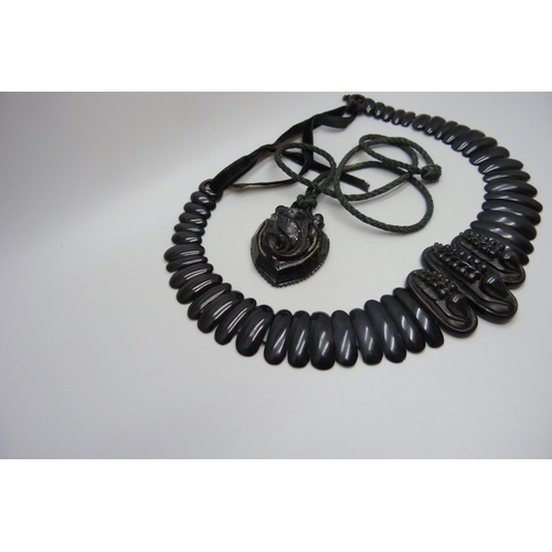 7157 - A circa 1900 Art Nouveau carved Whitby jet collar panel necklace, 56g, together with a pendant, 20g