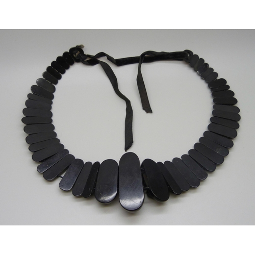 7157 - A circa 1900 Art Nouveau carved Whitby jet collar panel necklace, 56g, together with a pendant, 20g