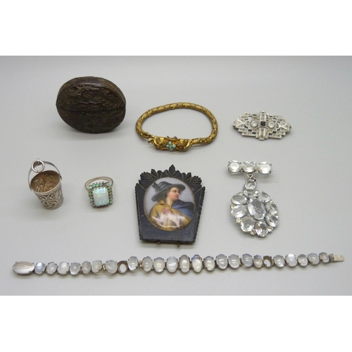 7160 - A white metal and moonstone bracelet (two stones missing) a silver and synthetic opal ring (lacking ... 