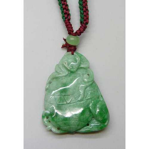 7161 - An Oriental carved jade pendant, 18g, 4 x 3cm