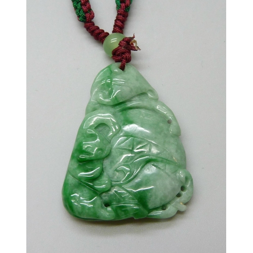 7161 - An Oriental carved jade pendant, 18g, 4 x 3cm