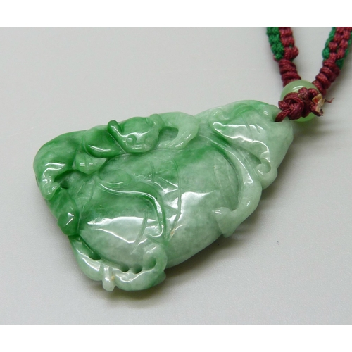 7161 - An Oriental carved jade pendant, 18g, 4 x 3cm