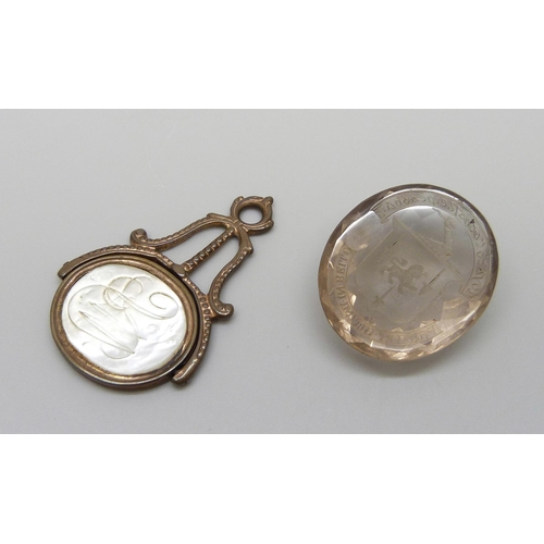 7162 - Two seals - a quartz stone with intaglio crest, and a spinning fob with portrait and monogram, 4.5cm