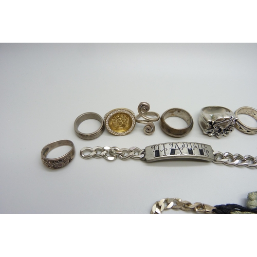 7164 - Seven silver rings, 45g, plated rings, a plated ID bracelet, an Ed Hardy skull ring etc.