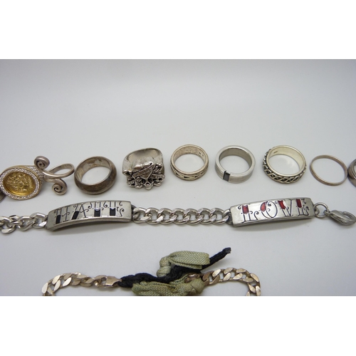 7164 - Seven silver rings, 45g, plated rings, a plated ID bracelet, an Ed Hardy skull ring etc.