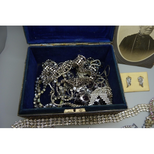 7168 - A collection of paste set costume jewellery in a plated Oriental box with dragon decoration