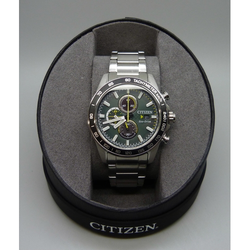 7199 - A Citizen Eco-Drive wristwatch with green dial and black bezel, boxed, 47mm including crown