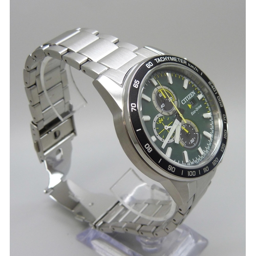 7199 - A Citizen Eco-Drive wristwatch with green dial and black bezel, boxed, 47mm including crown