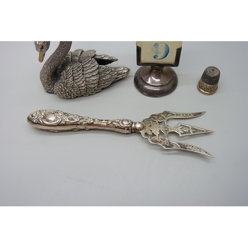 7229 - A silver covered model of a swan, hallmarked and stamped 'filled', a white metal propelling pencil s... 