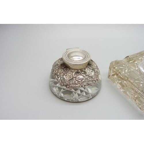 7236 - Two silver topped inkwells, ornate example Birmingham 1903, glass a/f on the other, 10.1 x 7.3cm