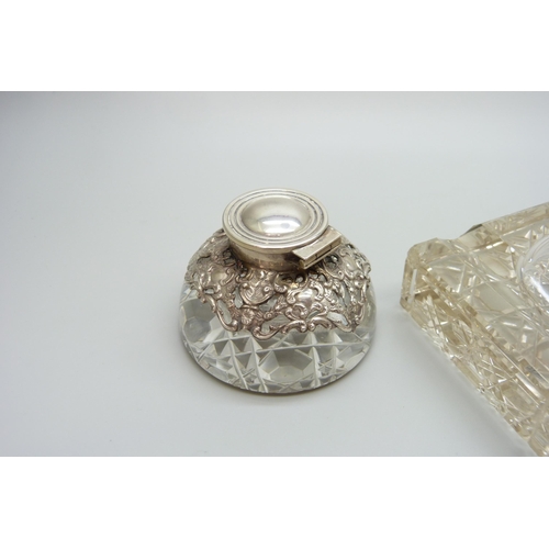 7236 - Two silver topped inkwells, ornate example Birmingham 1903, glass a/f on the other, 10.1 x 7.3cm