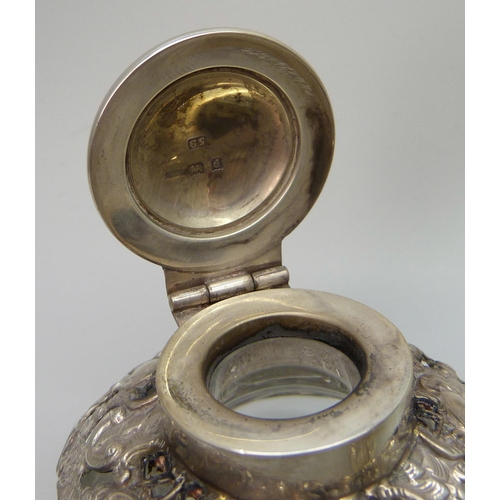 7236 - Two silver topped inkwells, ornate example Birmingham 1903, glass a/f on the other, 10.1 x 7.3cm