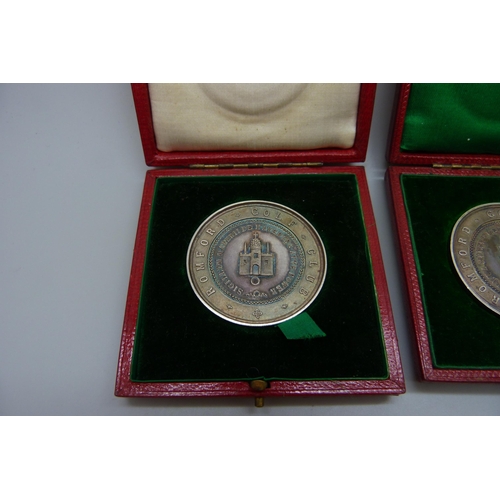 7304 - Two silver Romford Golf Club medallions, cased