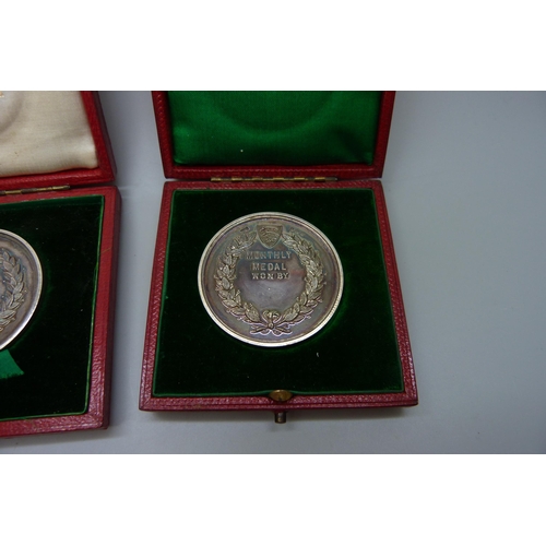 7304 - Two silver Romford Golf Club medallions, cased