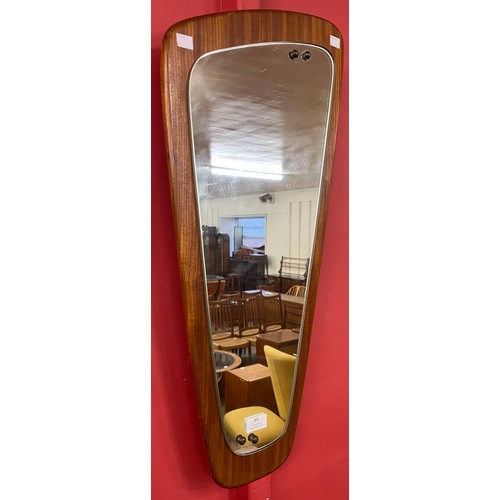 59 - An asymmetrical teak framed mirror