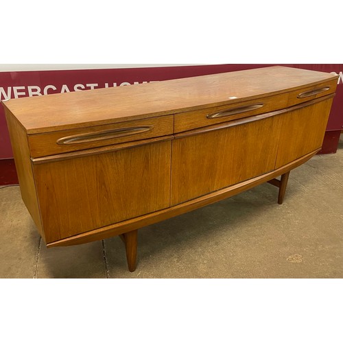 77 - A teak bowfront sideboard