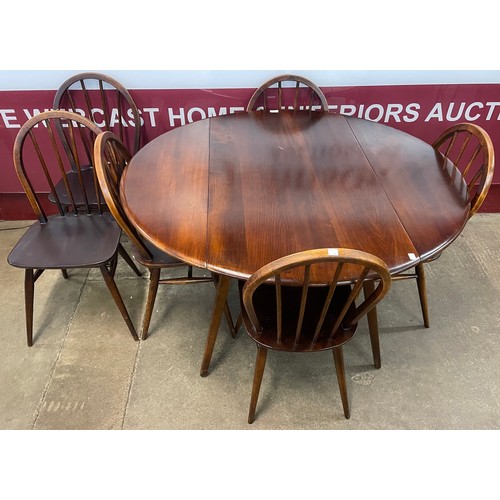 88 - An Ercol Golden Dawn elm and beech Windsor drop leaf table and six chairs