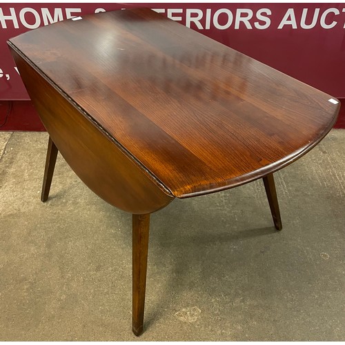 88 - An Ercol Golden Dawn elm and beech Windsor drop leaf table and six chairs