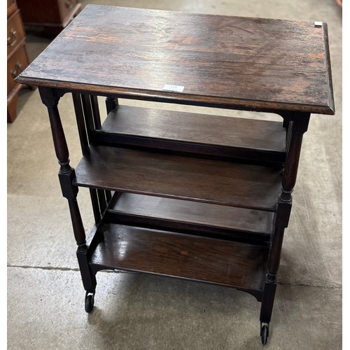 191 - An Arts and Crafts oak three tier bookstand/table