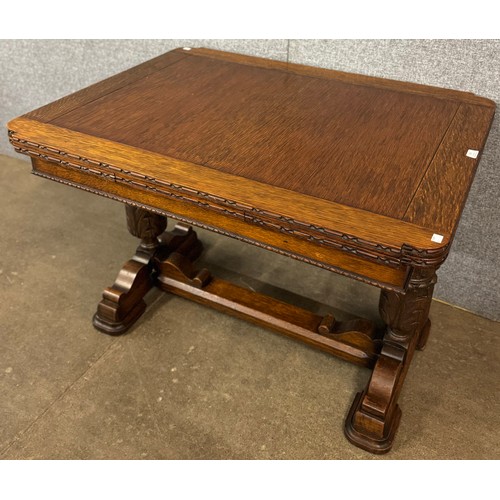 150 - An early 20th Century carved oak draw leaf table