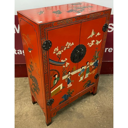 117 - An oriental style red lacquered chinoiserie side cabinet