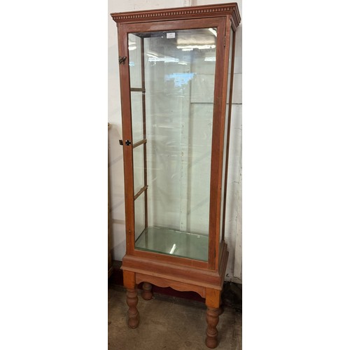 167 - An early 20th Century carved pine shop display cabinet