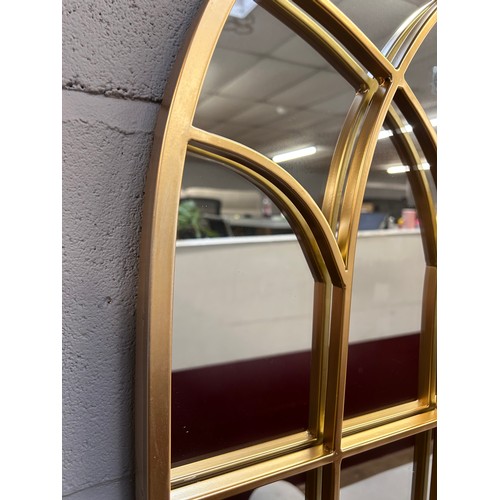 3053 - A gold metal framed church style mirror, 110cm