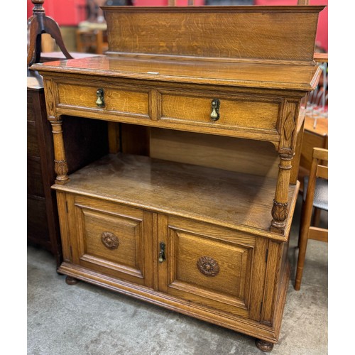 175 - An early 20th Century carved oak two tier buffet sideboard