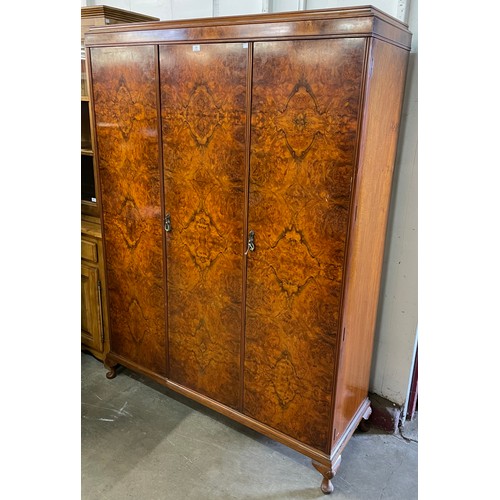 134 - An Art Deco figured walnut three door wardrobe