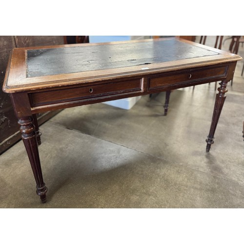 193 - A Victorian oak and blue leather topped two drawer writing desk