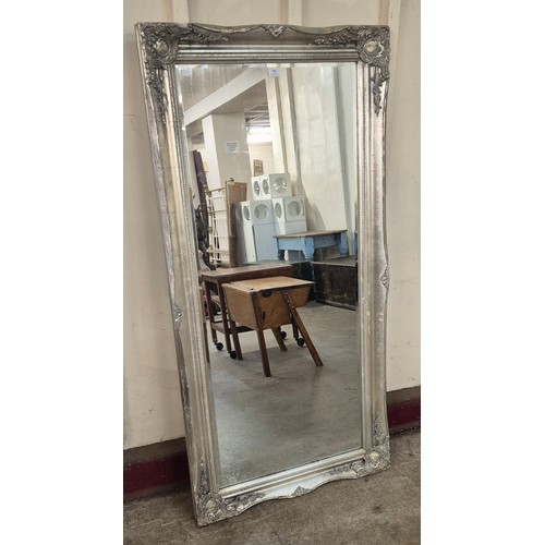 308 - A large French style silver effect framed mirror, 158 x 78cms