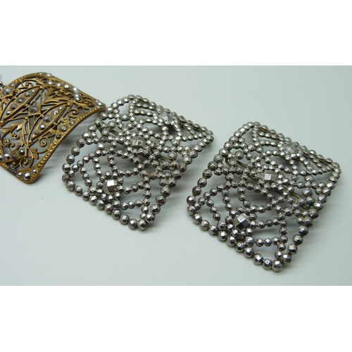 1002 - A pair of French cut steel buckles and one other, together with a comb marked 900