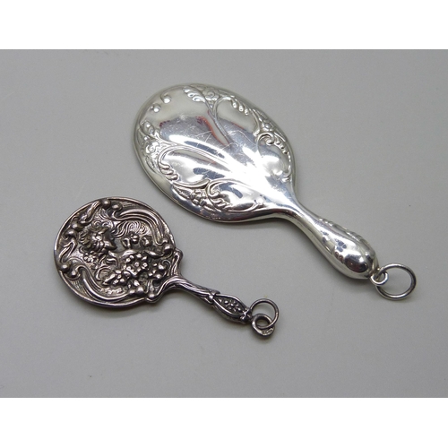 1003 - Two silver miniature hand mirrors, largest 7.5cm