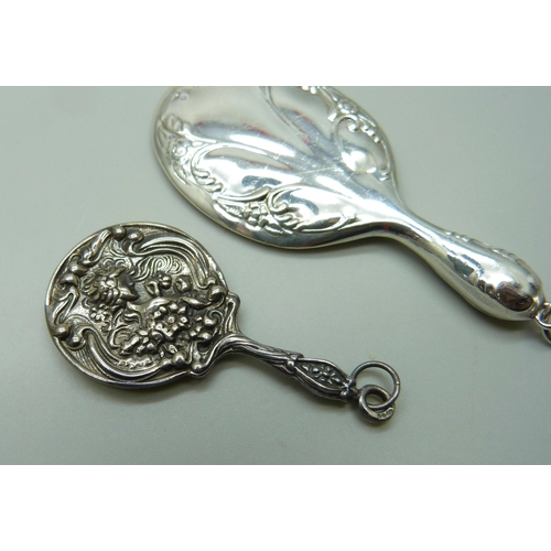 1003 - Two silver miniature hand mirrors, largest 7.5cm