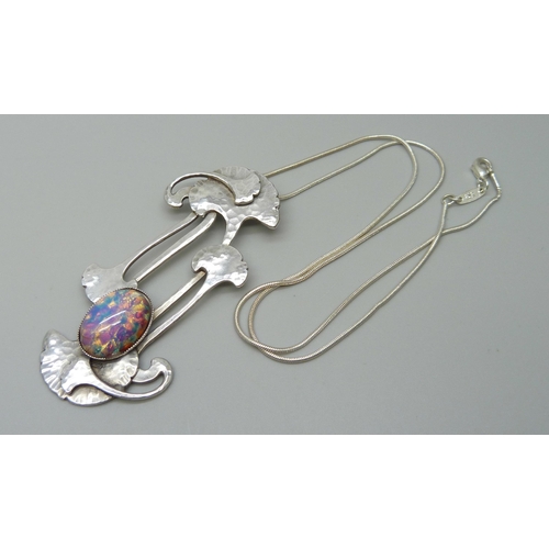 1006 - A modern Arts & Crafts style pendant with a glass stone, 7cm