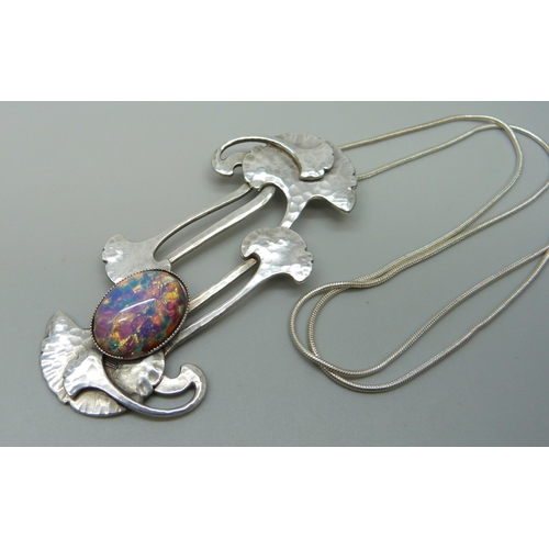 1006 - A modern Arts & Crafts style pendant with a glass stone, 7cm