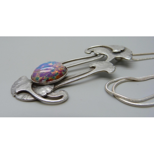 1006 - A modern Arts & Crafts style pendant with a glass stone, 7cm